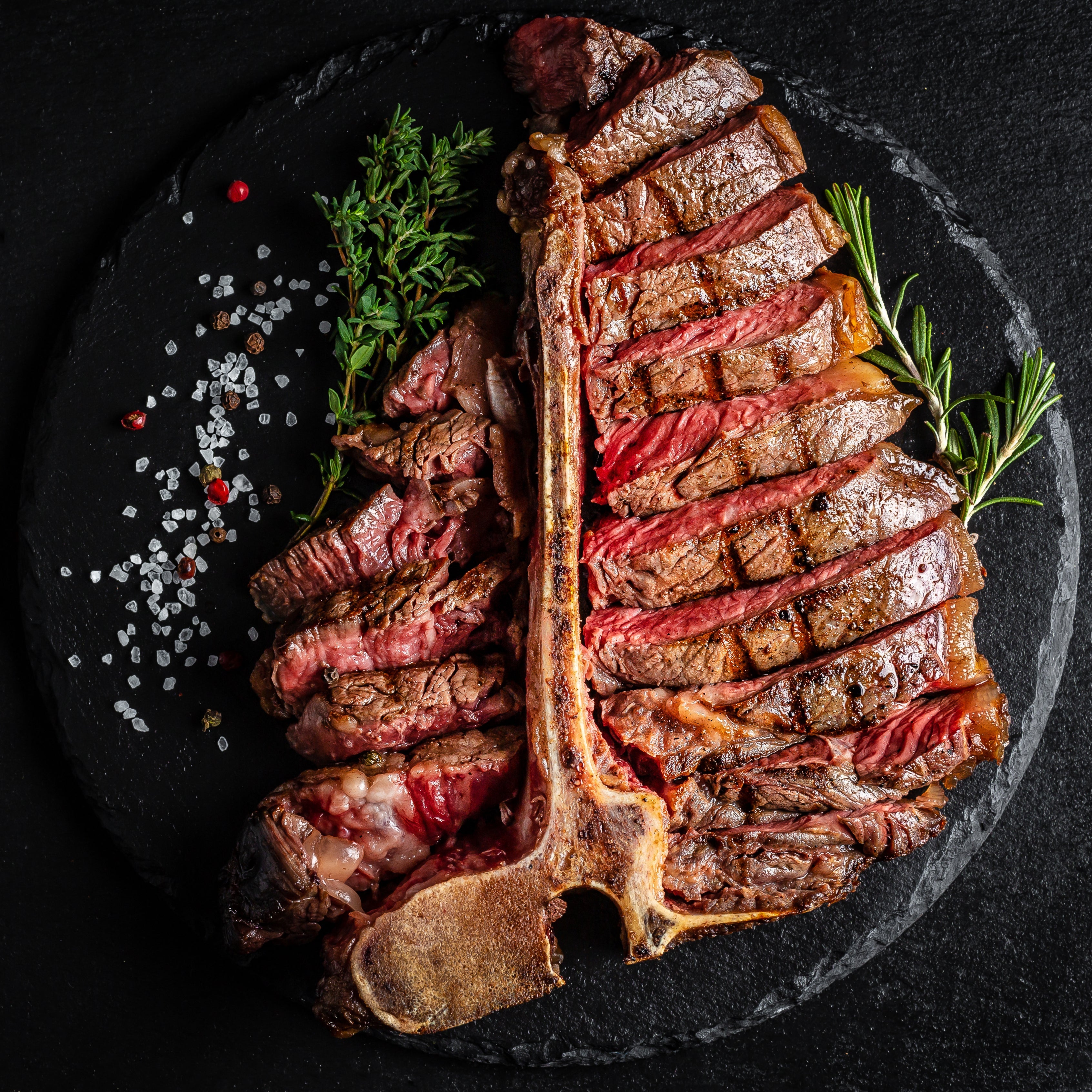 T-bone, ribeye, filet, and flank steaks seasoned with SALTOPIA infused sea salt, seared and richly crusted